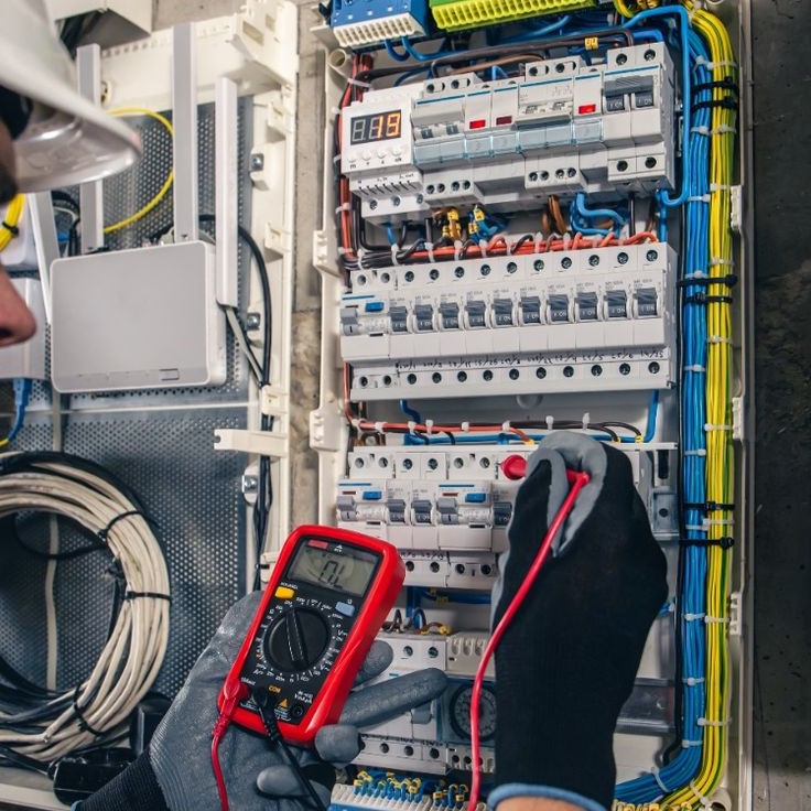 A man using an Electrical Gadget to measure electrical currents
