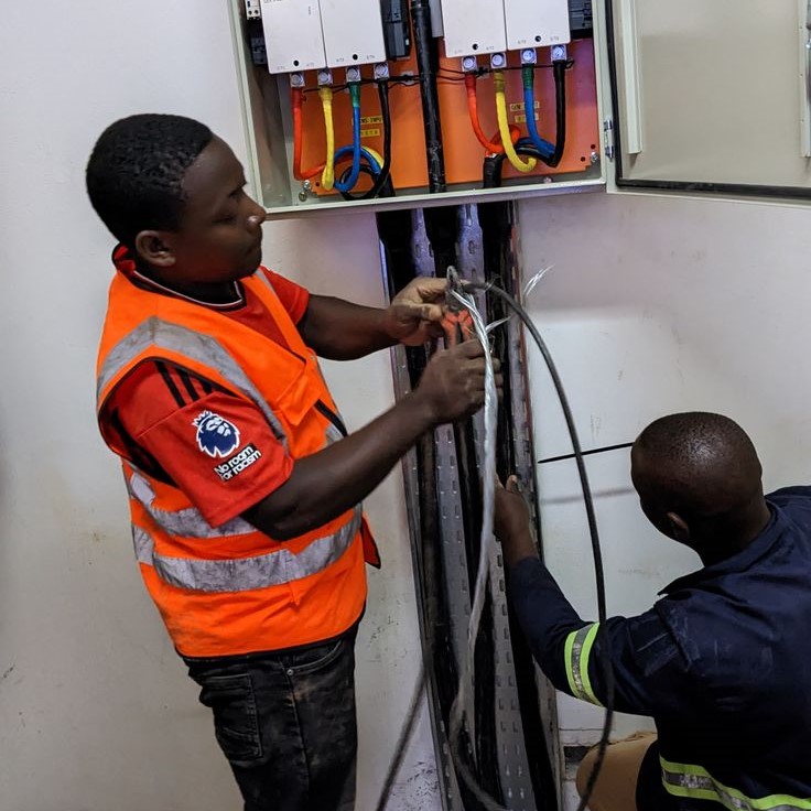 men fixing and repairing broken wires at a u-junction box